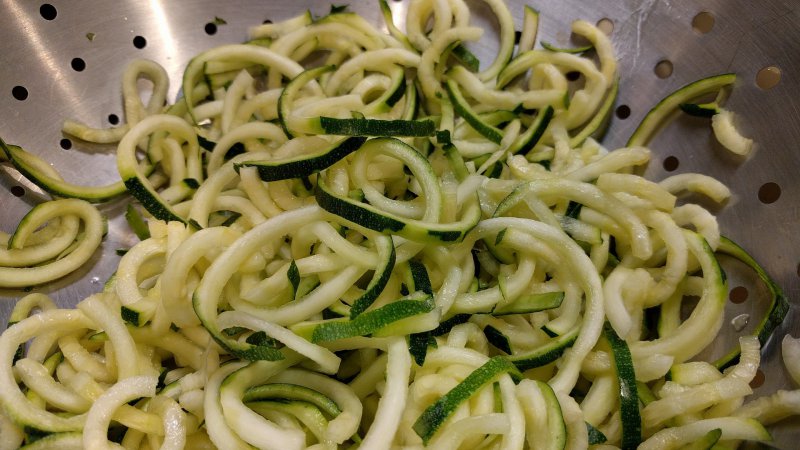 Geriebene Zucchini von einer Gemüsereibe 