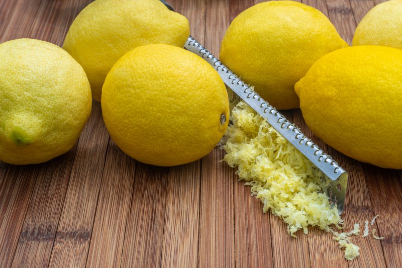 Zitronenschalen mit einer Ingwerreibe abgerieben Zitronenschalen mit einer Ingwerreibe abgerieben